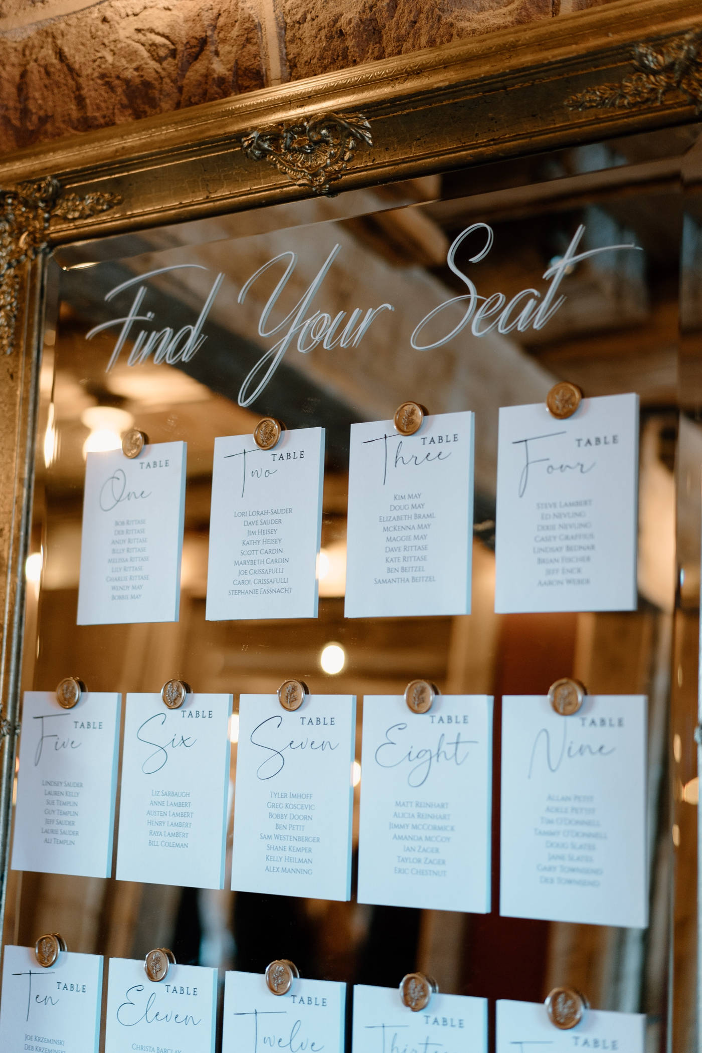 Gold mirror seating chart with calligraphy and gold wax seals