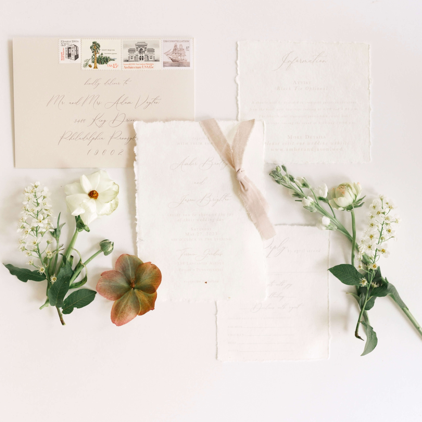 Flatlay photograph of a wedding invitation suite by RSVP Love